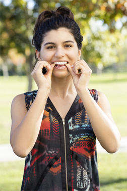 Invisalign Teen aligner held by woman